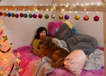 This dog lays down against an 11-year-old girl to comfort her when her diabetes worries her